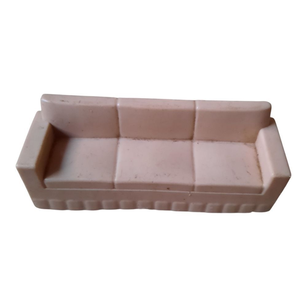 Marx hard plastic dollhouse sofa in a pale pink color. 